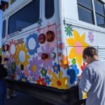 students painting bus